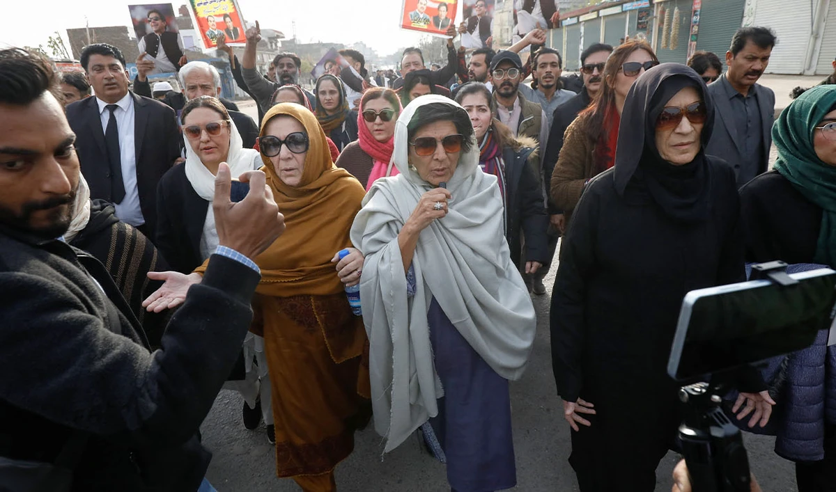 Aleema Khanum, Uzma Khanum and Noreen Niazi, sisters of jailed former Prime Minister of Pakistan and leader of Pakistan Tehreek-e-Insaf (PTI) party Imran Khan, walk with supporters during a protest over concerns about their brother's health, on a road leading to Adiala jail in Rawalpindi, Pakistan, December 9, 2025. (Reuters/File)