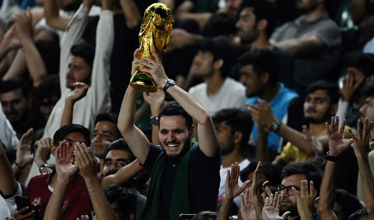 A fan holds a mock World Cup trophy during the FIFA World Cup 2026 Asia qualifiers football match between Pakistan and Saudi Arabia at the Jinnah Sports stadium in Islamabad on June 6, 2024. (AFP/File)