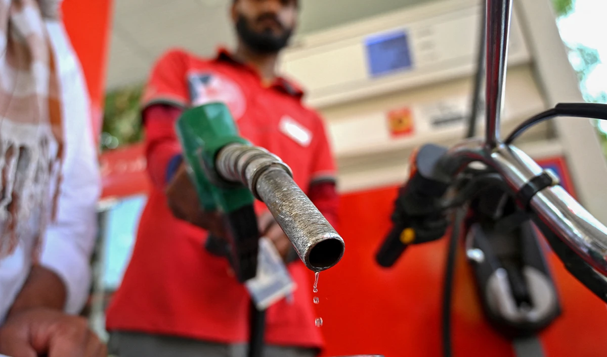 An employee fills the tank of a motorcycle at a fuel station in Islamabad on April 25, 2026. (AFP/File)