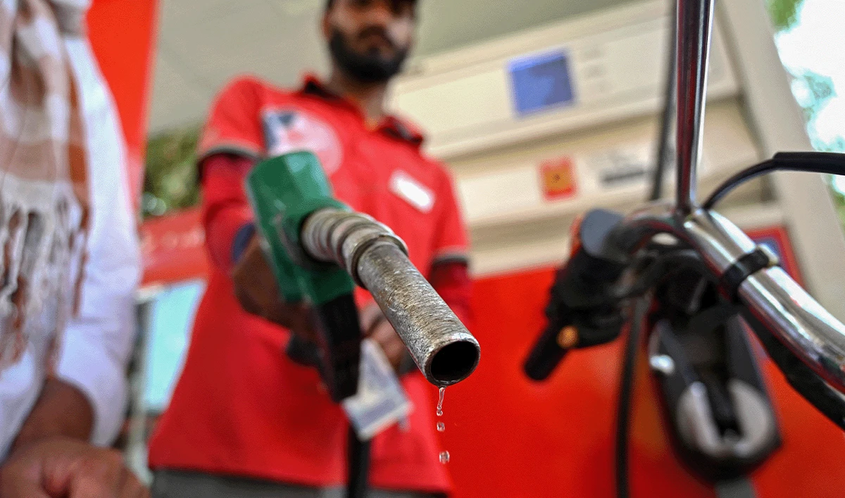 An employee fills the tank of a motorcycle at a fuel station in Islamabad, Pakistan on April 25, 2026. (AFP/File)