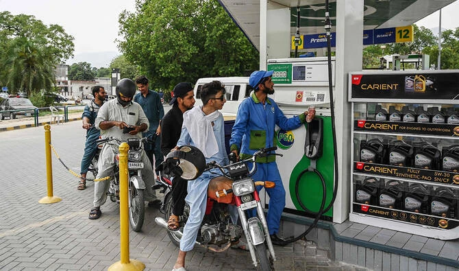 An employee fills the tank of a motorbike at a fuel station in Islamabad, Pakistan, on June 16, 2025. (AFP/File)