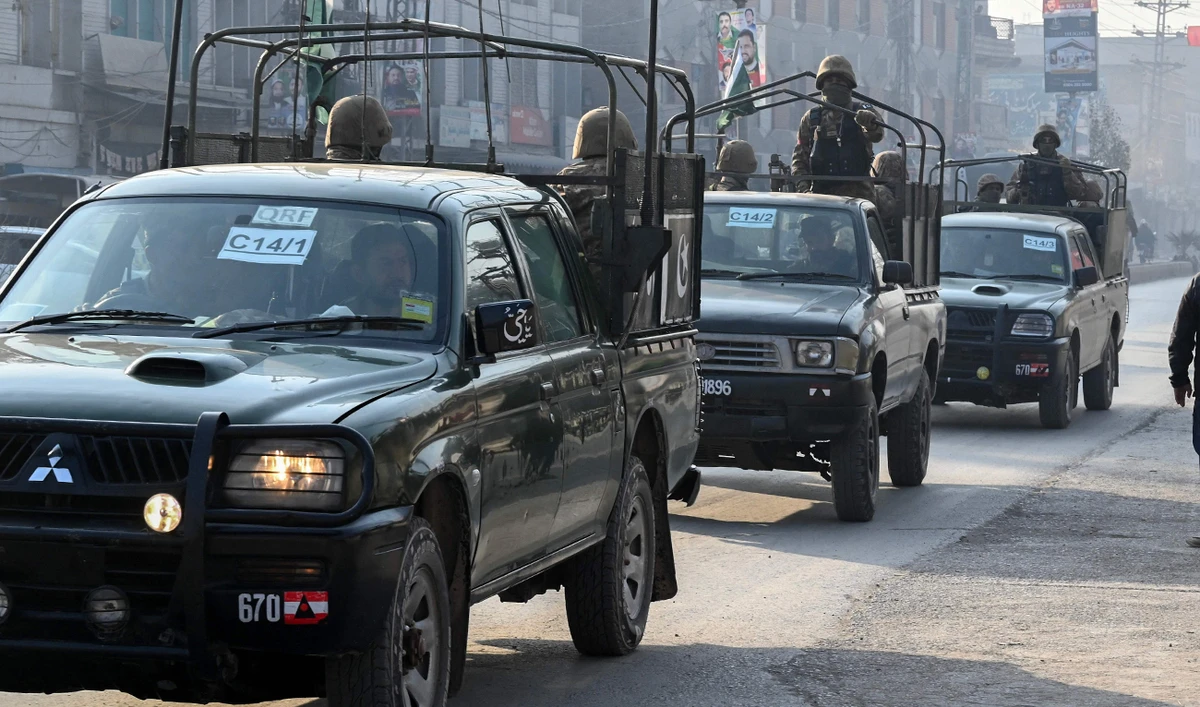 A Pakistan Army convoy patrols along a road in Peshawar on February 7, 2024. (AFP/File)