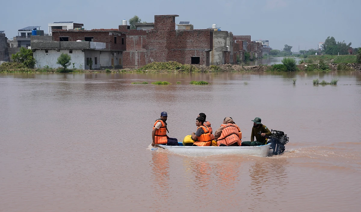 Rescue workers evacuate flood victims from a flooded area near Lahore, Pakistan, on July 27, 2026. (AP)