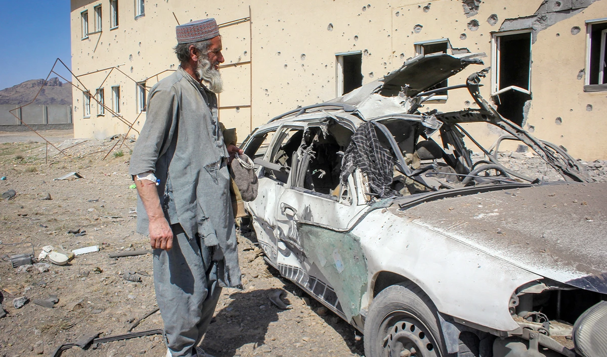 An Afghan man stands next to a damaged car following airstrikes, amid the conflict between Afghanistan and Pakistan, in Kandahar, Afghanistan, on February 28, 2026. (REUTERS/File)