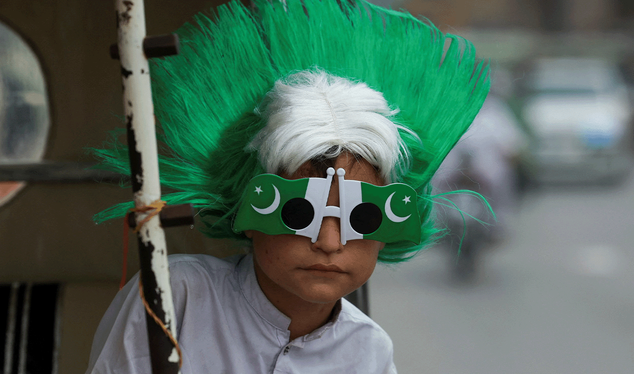A boy wears Pakistan's national flag-themed headwear and glasses during Independence Day celebrations in Peshawar, Pakistan, August 14, 2025. (Reuters/File)