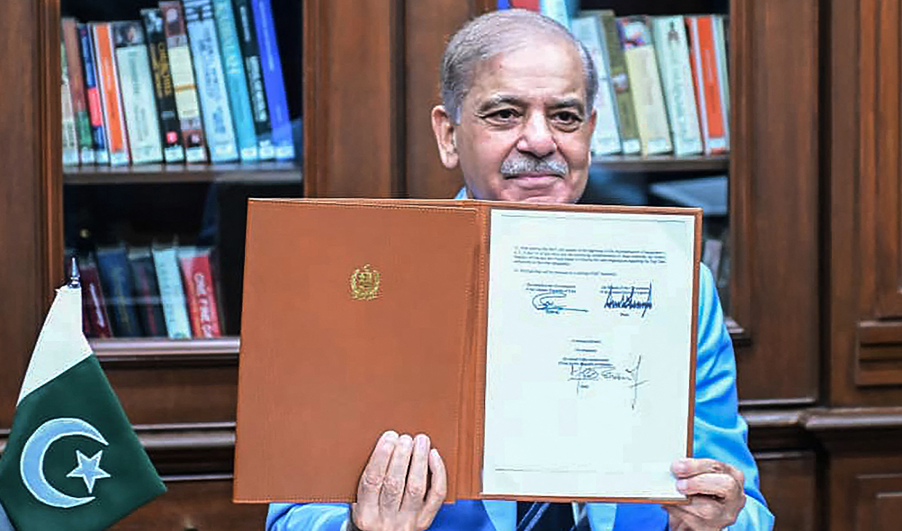 This handout photograph taken and released by Pakistan's Prime Minister's Office on June 18, 2026 shows Pakistan's Prime Minister Shehbaz Sharif holding the memorandum of understanding after signing it as a peace mediator to end the Middle East war, in Islamabad. (AFP/ file)