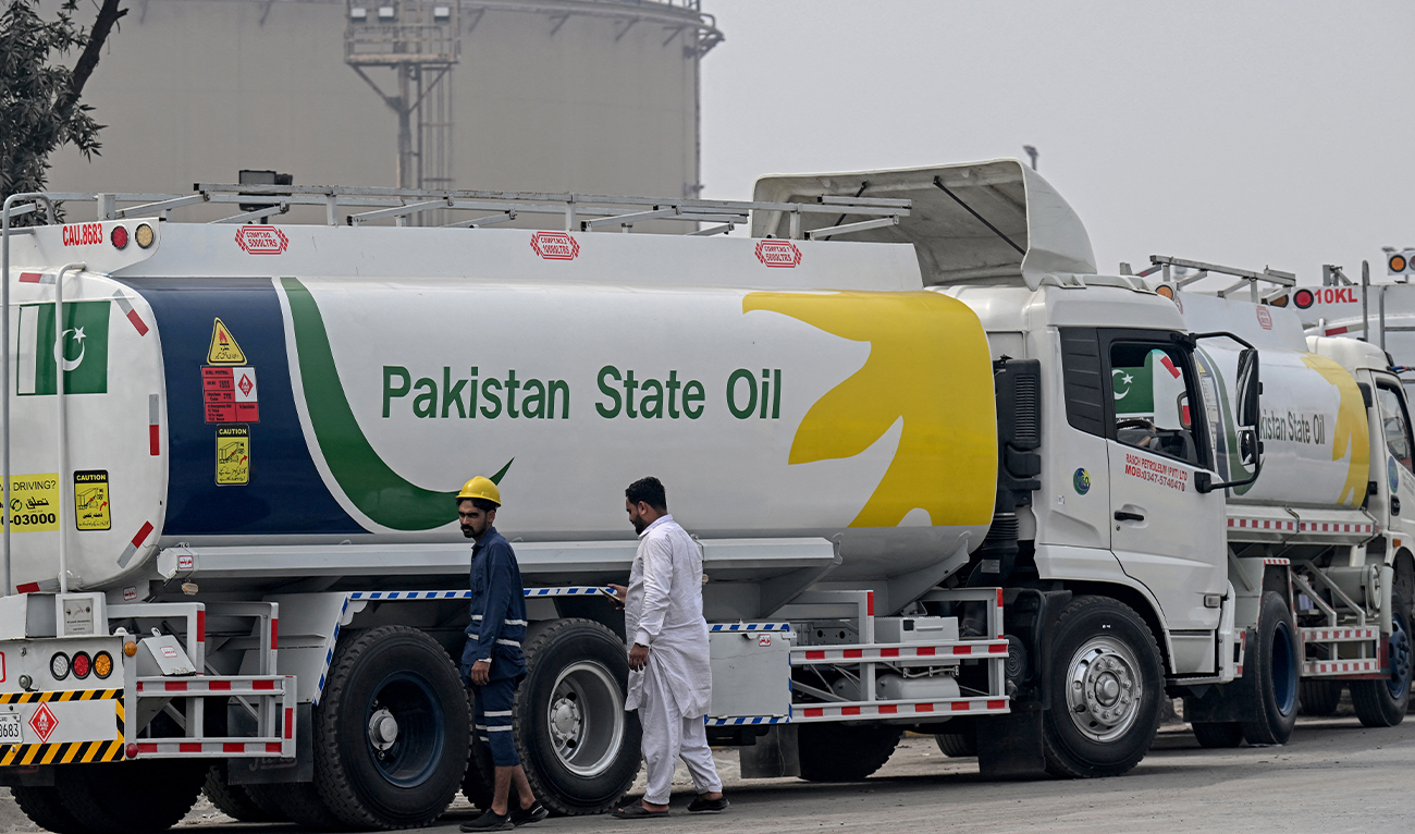 Workers inspect a Pakistan State Oil tanker as it lines up to enter a fuel storage facility in Sheikhupura district in Lahore on March 10, 2026. (AFP/ file)