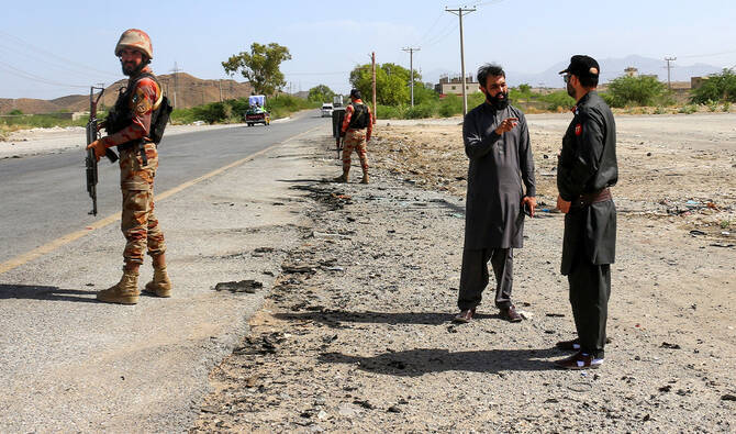 Security personnel stand guard at the site of a school bus bombing in Khuzdar district of Balochistan province on May 21, 2025. (AFP/ file)