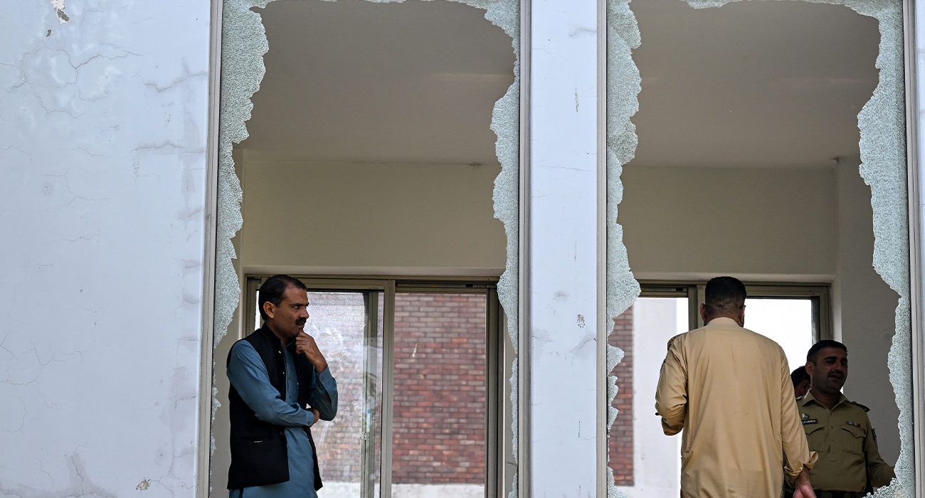 Security personnel stand in a damaged corridor at the site, a day after a fire at the Mother and Child Health ward of the Pakistan Institute of Medical Sciences (PIMS) Hospital in Islamabad on August 27, 2026. (AFP)