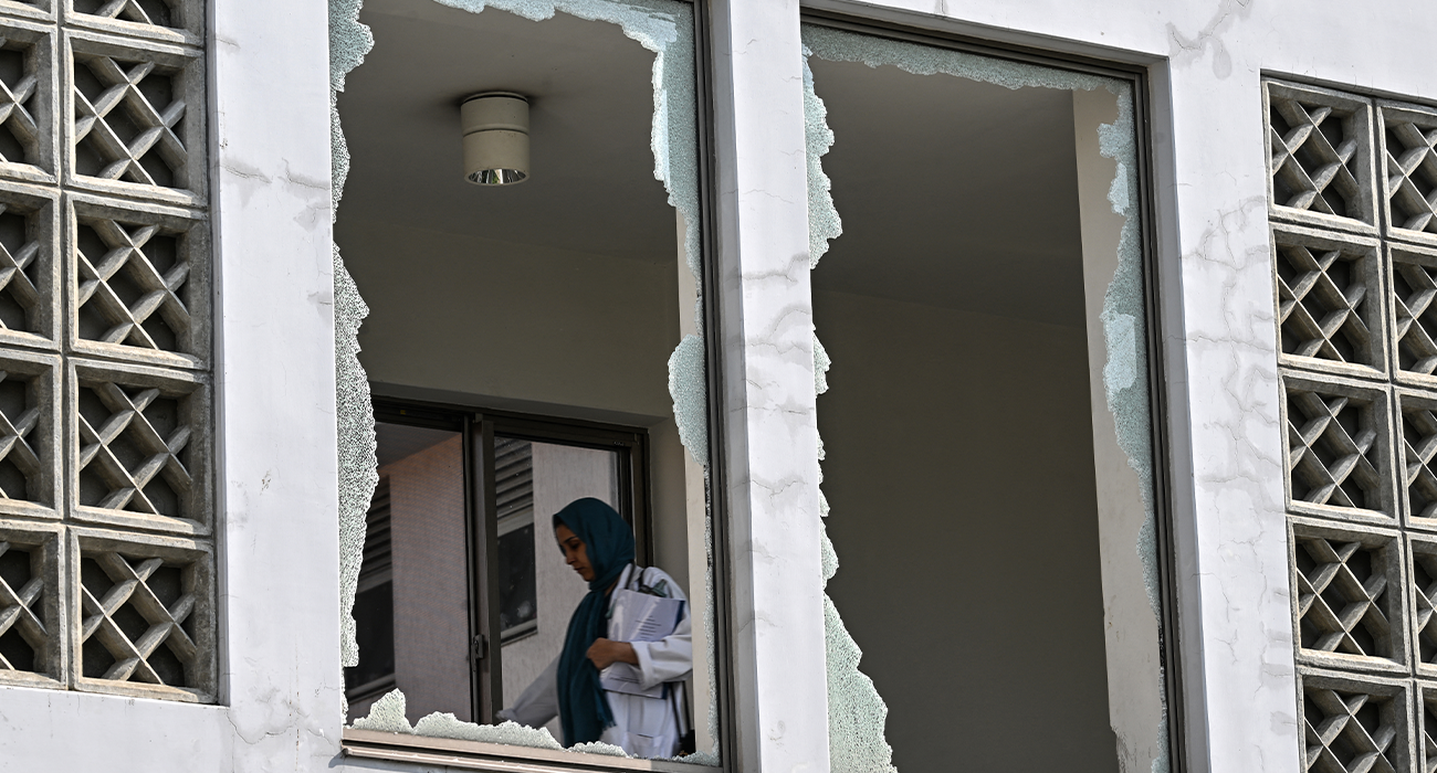 A medical staff member walks past a damaged corridor at the site, a day after a fire at the Mother and Child Health ward of the Pakistan Institute of Medical Sciences (PIMS) Hospital in Islamabad on August 27, 2026. (AFP/File)