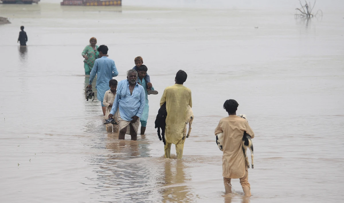 People wade through a flooded road following monsoon rains, in Muridke, Pakistan July 28, 2026. (Reuters/File)