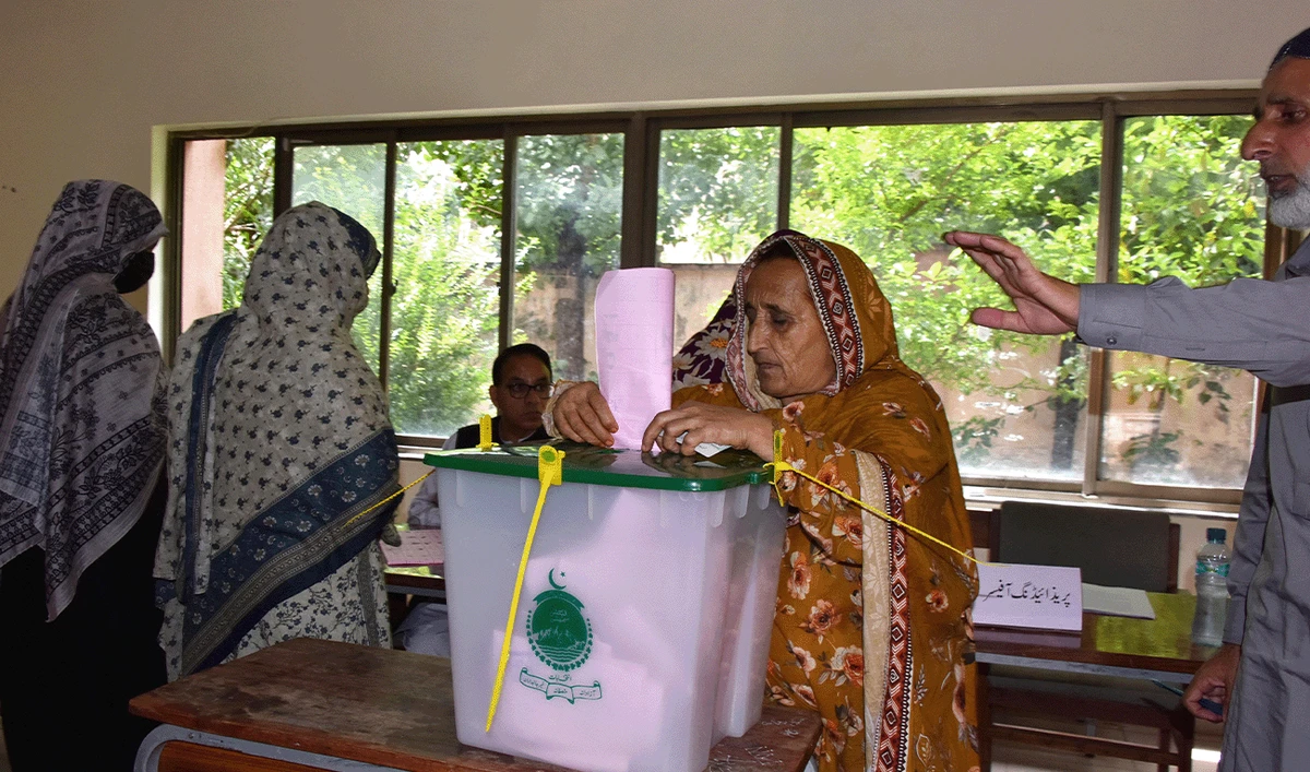 A woman casts her ballot at a polling station during the second phase of elections for the local legislative assembly in Muzaffarabad, Azad Kashmir, on August 2, 2026. (AFP/File)