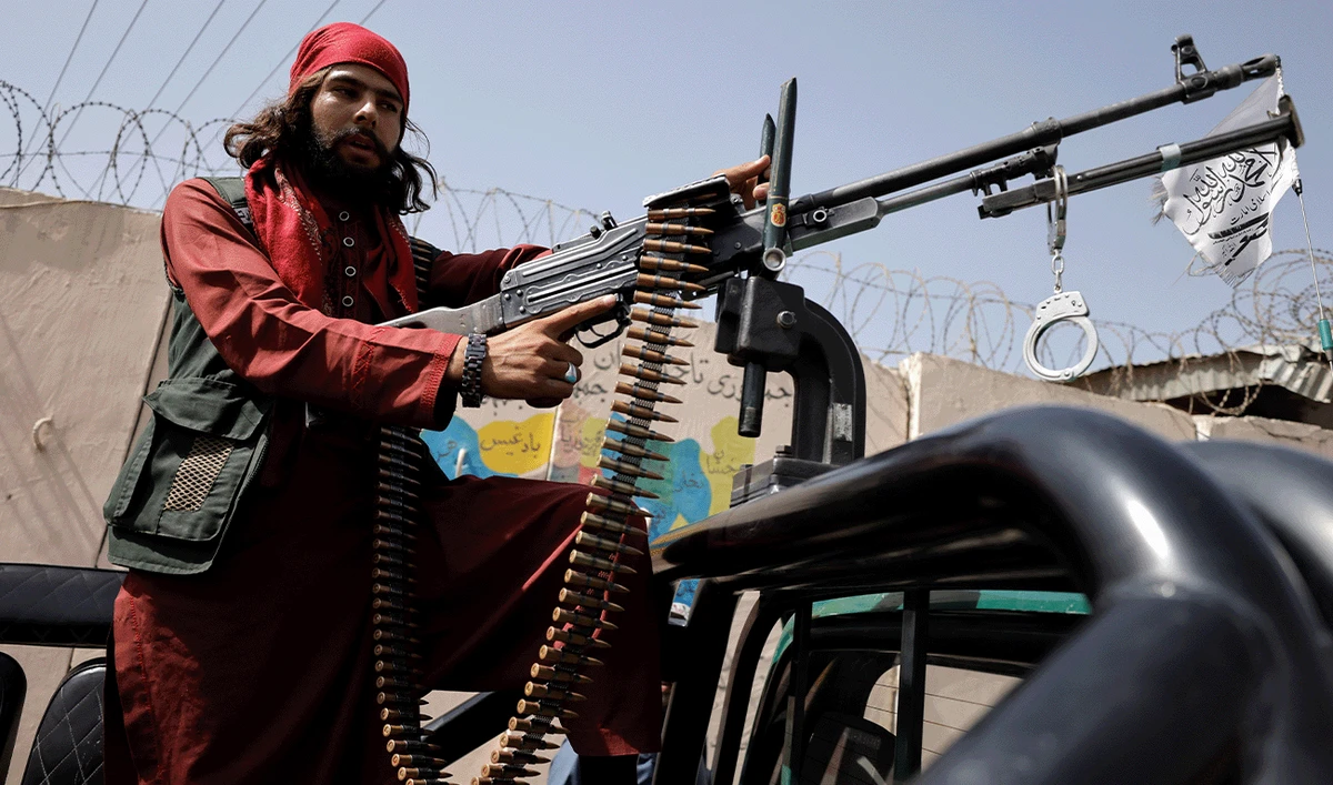 A member of Taliban forces rides on a pick-up truck mounted with a weapon in Kabul, Afghanistan, October 3, 2021. (Reuters/File)