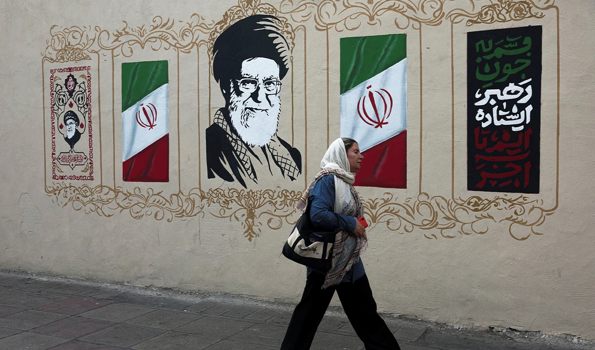 A woman walks by a mural depicting Iran's late Supreme Leader Ayatollah Ali Khamenei, on a street in Tehran, Iran, August 13, 2026. (Reuters/File)