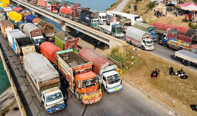 An aerial view shows a road blocked with shipping containers and freight trucks in Swabi, Pakistan, on November 24, 2024. (AFP/File)