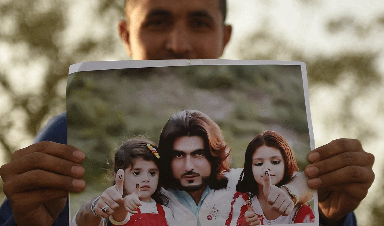 In this photograph taken on January 23, 2018, a Pakistani protester holds a photograph of 23-year-old man Naqeebullah Mehsud, during a protest in Karachi. (AFP/File)