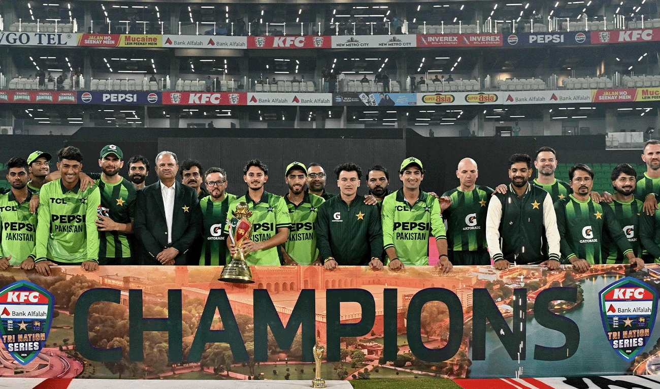 Pakistan's players celebrate with the trophy after their team's win at the end of the one-day international (ODI) tri-series final cricket match between Pakistan and Sri Lanka in the Gaddafi Stadium of Lahore on October 31, 2026. (AFP)