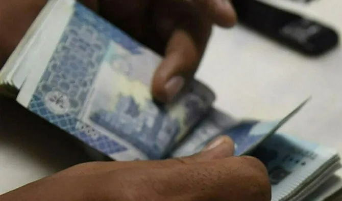 An undated file photo of a man counting Pakistani currency notes. (Shutterstock/ file)
