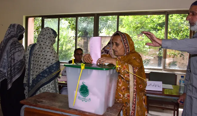 A woman casts her ballot at a polling station during the second phase of elections for the local legislative assembly in Muzaffarabad, Pakistan-administered Kashmir, on August 2, 2026, amid unrest in parts of the region. (AFP/ file)