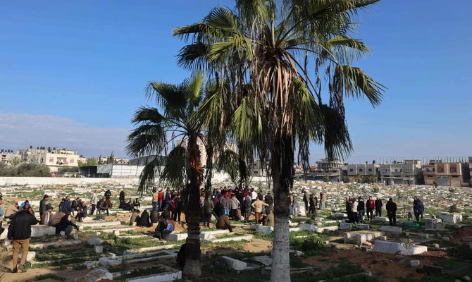 People bury their dead on January 5, 2024, in Rafah on the southern Gaza Strip following Israeli bombardment, amid continuing battles between Israel and the Palestinian militant group Hamas. (AFP)
