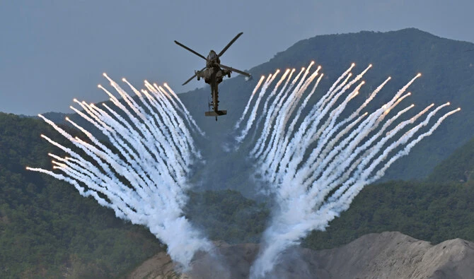 South Korea's Apache AH-64 helicopter fires flares during a South Korea-US joint military drill at Seungjin Fire Training Field in Pocheon on June 15, 2023. (AFP/File)