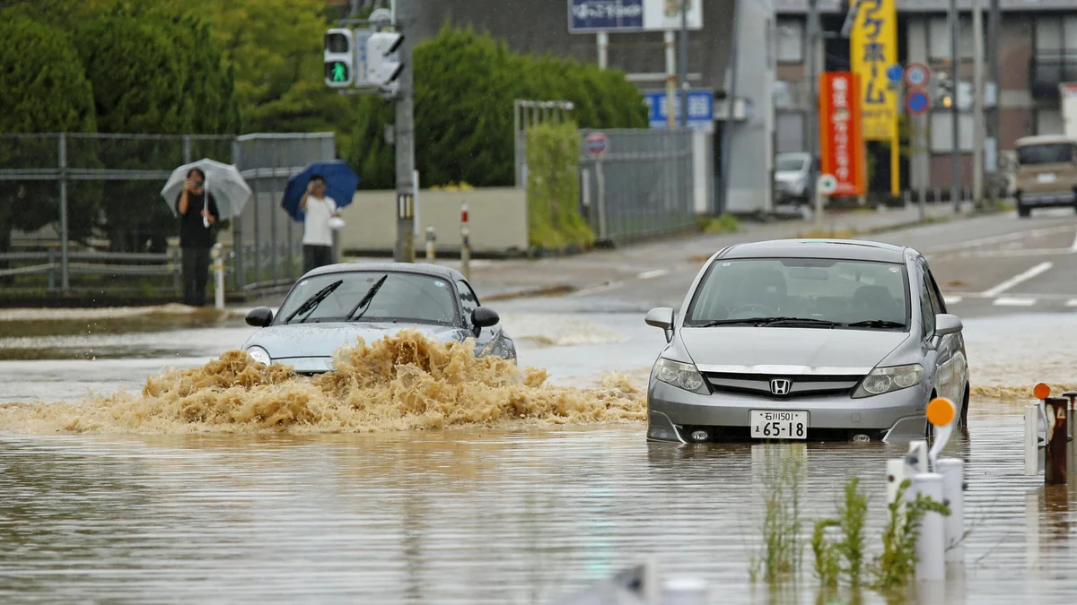 Heavy rain and flooding in north-central Japan strands people and vehicles