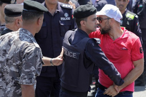 Un policier arrête un enseignant jordanien lors d'une manifestation à Amman le 5 septembre 2019. (AFP)