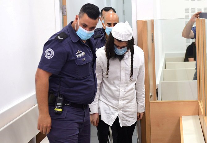 Amiram Ben-Uliel est traduit en justice dans l'affaire de l'incendie criminel de 2015, qui a tué un enfant palestinien et ses parents dans le village de Douma, occupé par Israël en Cisjordanie, au tribunal du district central de Lod à Lod, Israël, le 18 mai 2020. (Reuters)