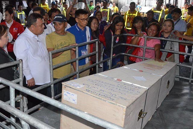Sur cette photo publiée par le Ministère des Affaires étrangères des Philippines, des proches de Jeanelyn Padernal Villavende pleurent alors que la boîte contenant la dépouille arrive aux Philippines. (Fichier photo)