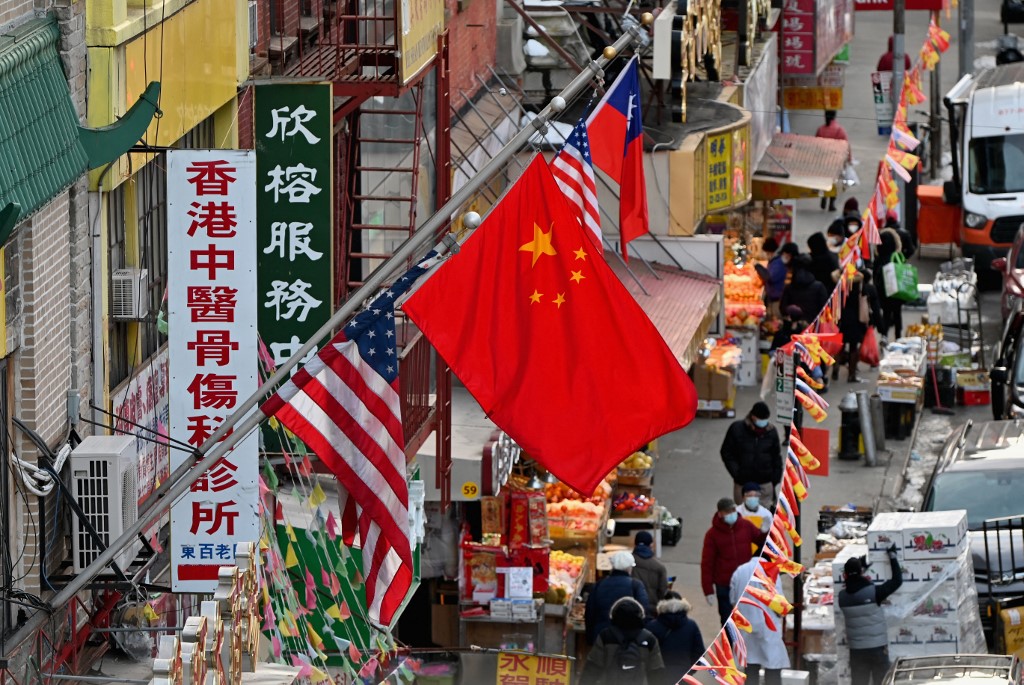 Un drapeau chinois est suspendu entre les drapeaux américains à Chinatown à New York. (Photo, AFP)