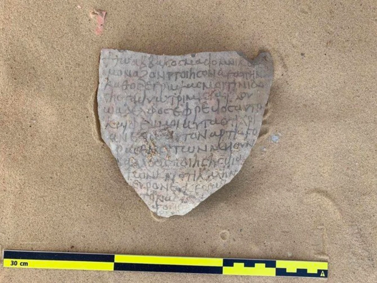 Cette photographie montre des inscriptions chrétiennes anciennes inscrites sur un fragment d'argile découvert sur le site de Tal Ganoub Qasr Al-Ajouz dans l'oasis d’Al-Bahariya, située dans le désert occidental égyptien. (Photo AFP)