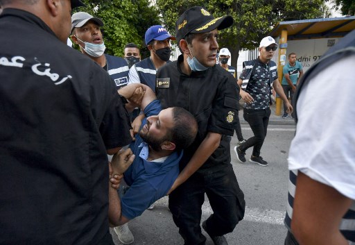 Des policiers tunisiens arrêtent un manifestant lors d'une manifestation contre les violences policières à l'avenue Habib Bourguiba dans la capitale Tunis, le 12 juin 2021 (Photo, AFP)