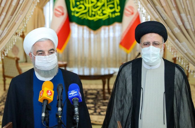 Le président iranien Hassan Rouhani, (g), se joint au président élu Ebrahim Raïssi lors d'une conférence de presse pour féliciter ce dernier pour sa victoire dans une élection dans laquelle la plupart des rivaux importants ont été exclus. (AFP)