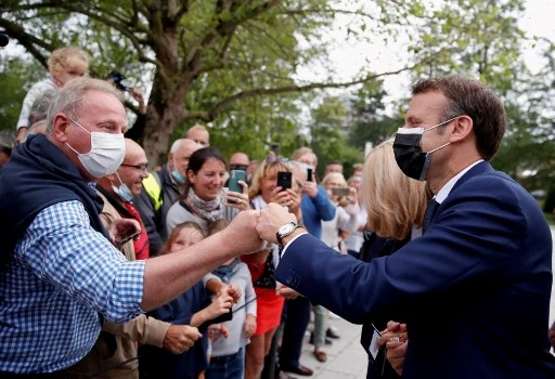 Le président français Emmanuel Macron salue un électeur au bureau de vote du Touquet, lors du premier tour des élections régionales françaises le 20 juin 2021 (Photo, AFP)