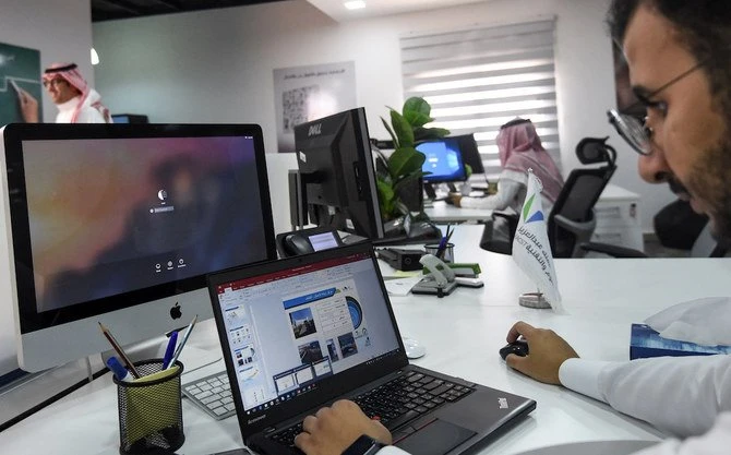 Une photo prise le 17 août 2017 montre un employé saoudien utilisant un ordinateur portable pour préparer un diaporama dans son bureau de Riyad (Fichier Photos/AFP)