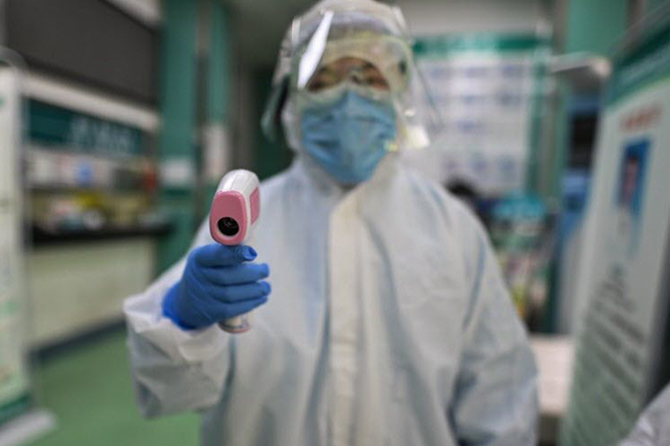 Prise de température en 2020 à Wuhan en Chine, ville où le coronavirus serait apparu. Photo / AFP