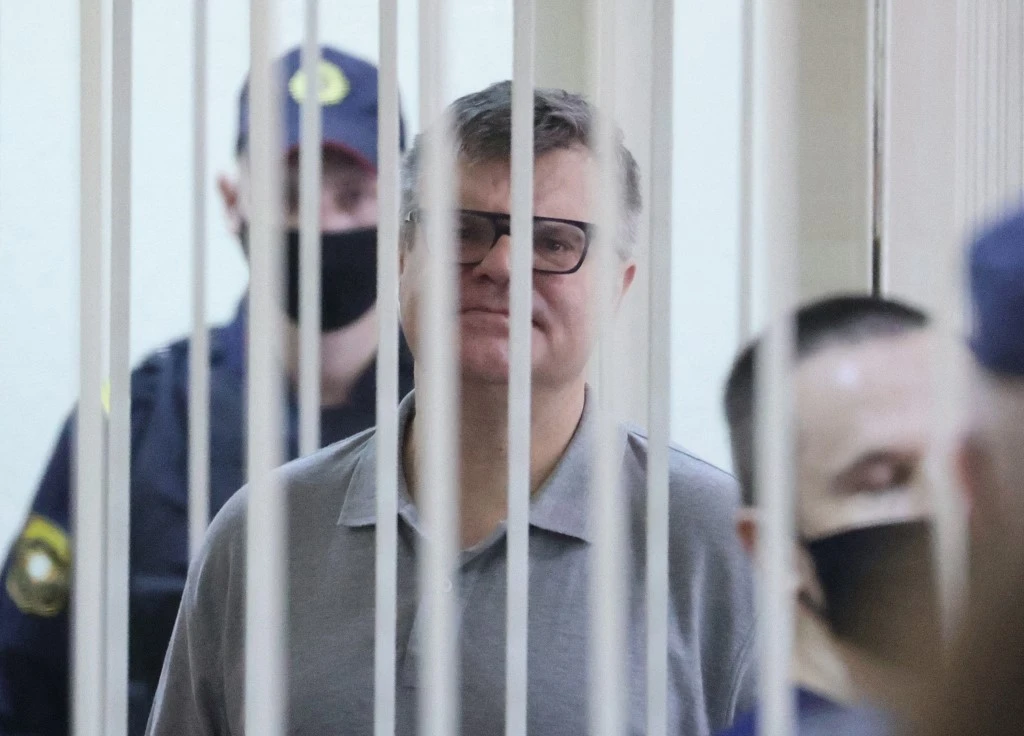 Le politicien et banquier de l'opposition Viktor Babaryko, accusé de corruption et de blanchiment d'argent, se tient à l'intérieur d'une cage d'accusés lors de sa condamnation à Minsk le 6 juillet 2021 (AFP)