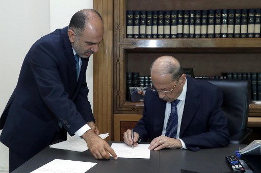 Une photo fournie par l'agence photo libanaise Dalati et Nohra le 10 septembre 2021 montre le président Michel Aoun signant un décret pour la formation d'un nouveau gouvernement libanais après une rencontre avec le Premier ministre désigné au palais présidentiel de Baabda, à l'est de la capitale Beyrouth. (Stringer/AFP/Dalati et Nohra)