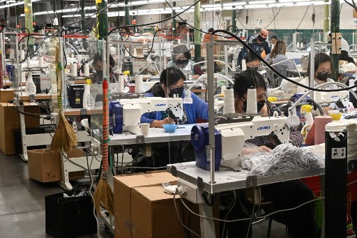 Des employés travaillent sur des machines à coudre à l''atelier résilience' à Roubaix, dans le nord de la France, le 21 octobre 2021. Cette ancienne terre textile peine à trouver des ouvriers. (Denis Charlet/AFP)