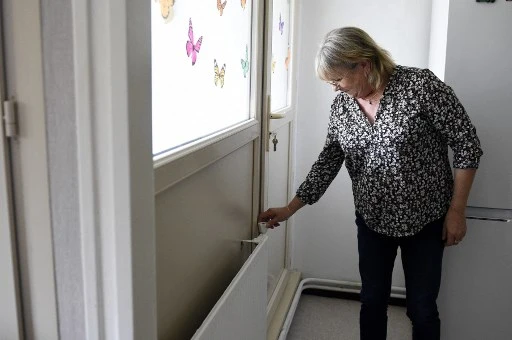 Colette Michel, 65 ans, règle un radiateur dans son appartement de Bar-le-Duc, dans l'est de la France, le 25 octobre 2021.Comme des millions d'autres Français touchés par l'augmentation du coût de l'énergie, Colette peine à payer ses factures. (Jean-Christophe Verhaegen/AFP)