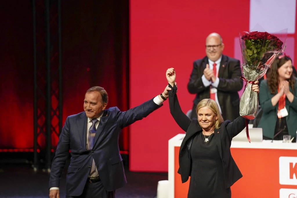 La ministre suédoise des Finances Magdalena Andersson soulève un bouquet de roses rouges et est félicitée par son prédécesseur, le Premier ministre Stefan Löfven après avoir été élue présidente du Parti social-démocrate au congrès du Parti social-démocrate à Göteborg, Suède, le 4 novembre 2021. (AFP)