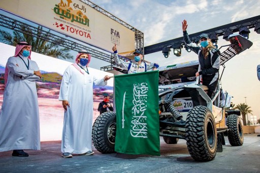 Une photo fournie par le Sharqiyah International Baja Toyota le 4 mars 2021 montre la coureuse Dania Akeel, toute première femme saoudienne à s'attaquer à un rallye international, à côté de son véhicule, en Arabie saoudite. (Ahmed Nureldine / Bureau de presse Toyota Rallye / AFP)