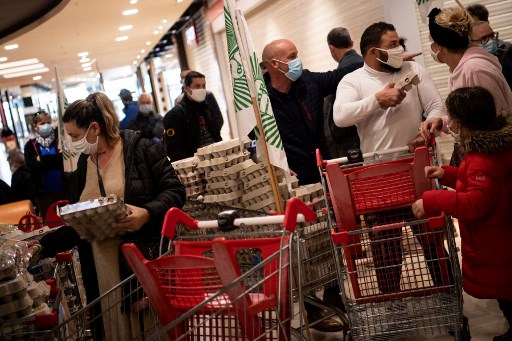 Les producteurs d'œufs et les membres des syndicats agricoles FNSEA et JA proposent aux clients des produits fabriqués avec des œufs non français qu'ils ont pris dans les rayons d'un supermarché de Saint-Sébastien-Sur-Loire le 17 février 2021. (Loïc Venance/AFP)