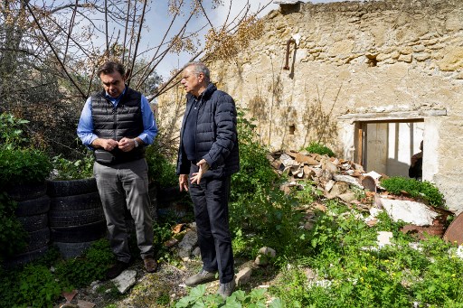 Le ministre chypriote de l'intérieur Nicos Nouris (à droite) et le vice-président de la Commission européenne Margaritis Schinas (à gauche) dans la vieille ville fortifiée divisée de Nicosie, la capitale chypriote, près de la zone tampon des Nations Unies, le 20 février 2022. (AFP)