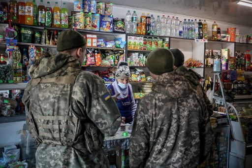 Les militaires ukrainiens font leurs courses dans la ville d'Avdiivka, dans la région de Donetsk, sur la ligne de front de l'est de l'Ukraine avec des séparatistes soutenus par la Russie le 21 février 2022. (Alexeï Filippov / AFP)