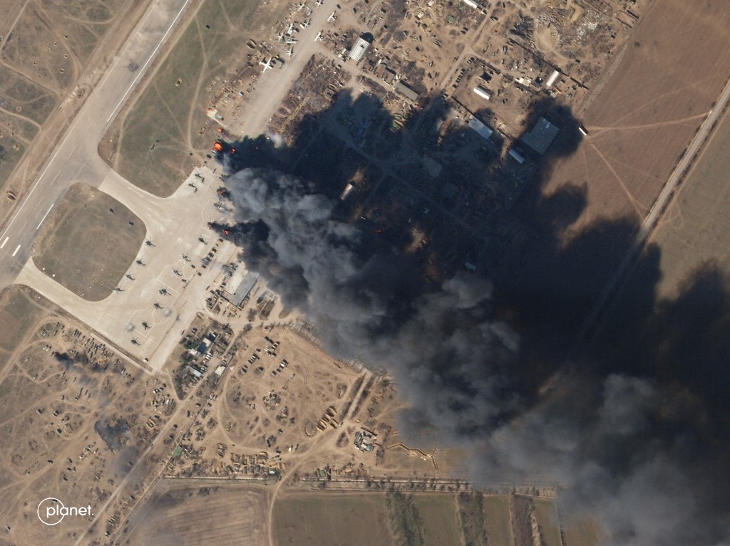 Cette image satellite Planet Labs prise le 15 mars 2022 et publiée le 16 mars 2022 montre la base aérienne de Kherson en feu après une prétendue frappe aérienne contre les forces russes qui occupent la base. (AFP).