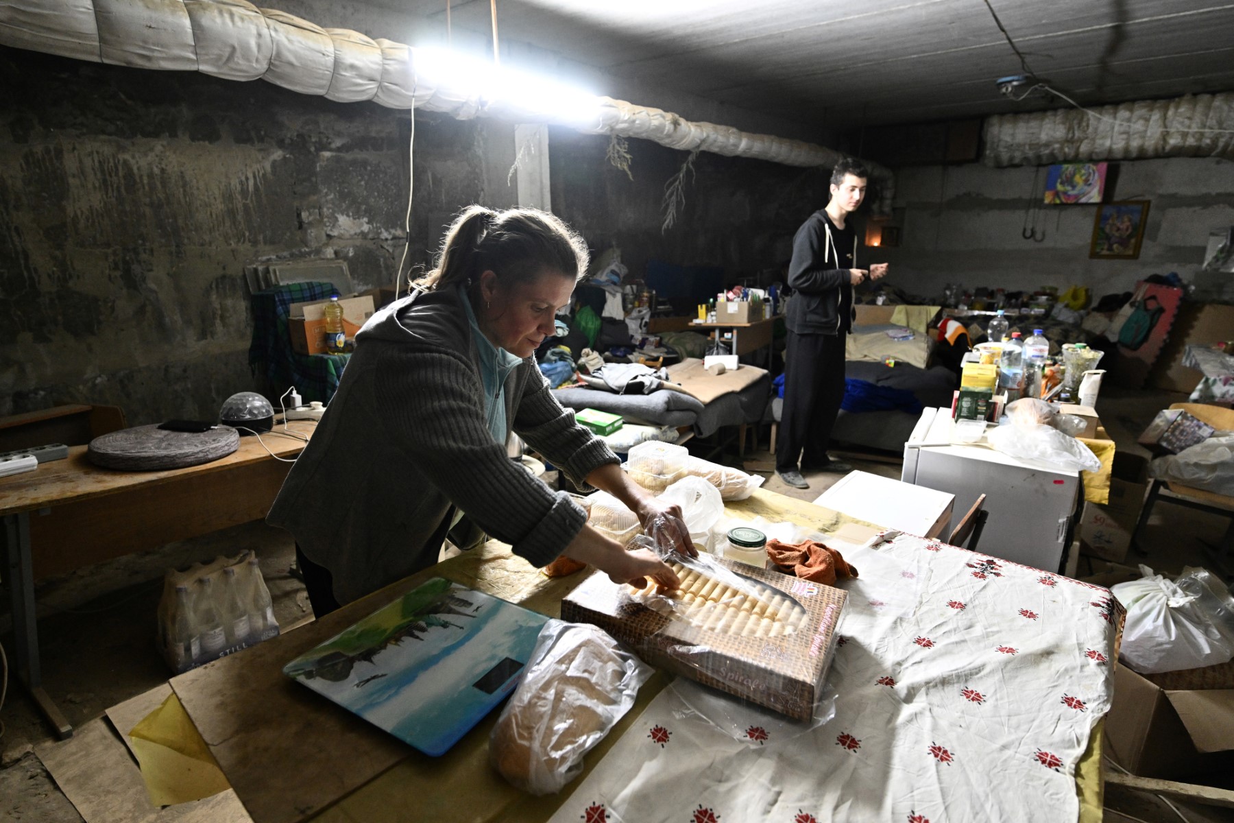 Natalia, 44 ans, prépare de la nourriture dans la cave où elle vit pour se protéger des bombardements à Saltivka, un quartier nord de la deuxième plus grande ville ukrainienne, Kharkiv, le 29 juillet 2022. (Photo, Genya Savilov / AFP)