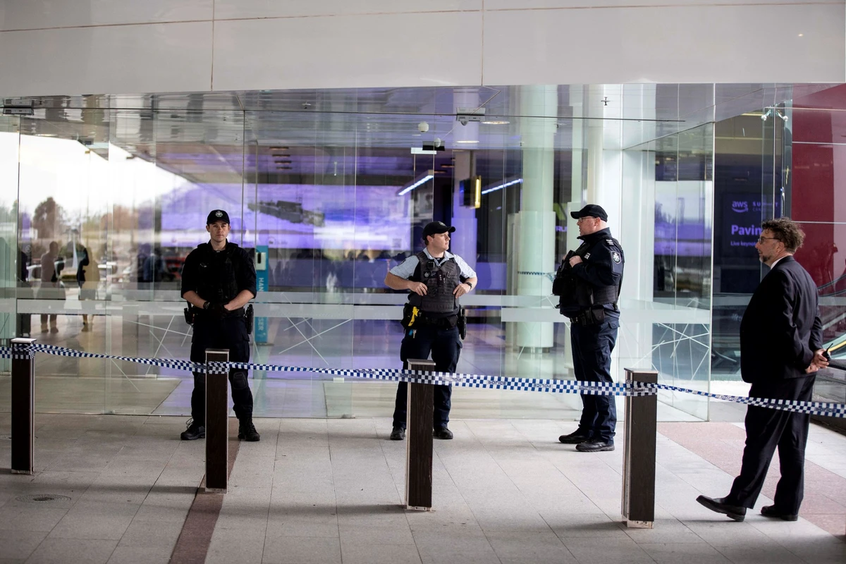 Des policiers montent la garde à l'entrée d'un terminal après qu'un homme armé a ouvert le feu à l'aéroport de Canberra, le 14 août 2022. (Photo de l'AFP)