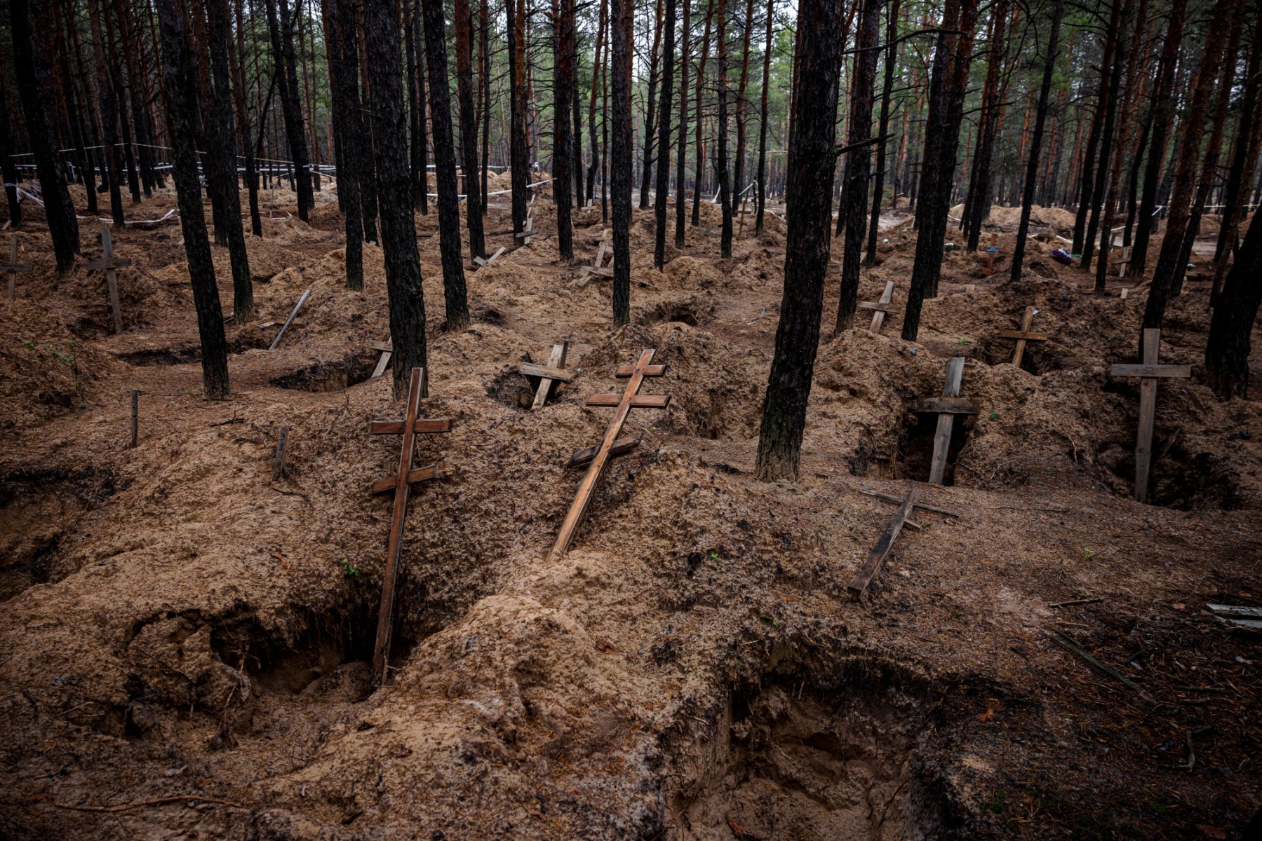 Cette photo prise le 4 novembre 2022 montre des tombes vides après l'exhumation des corps dans les fosses communes creusées pendant l'occupation russe dans la ville d'Izyum, dans la région de Kharkiv, lors de l'invasion russe de l'Ukraine. (Photo de Dimitar DILKOFF / AFP)
