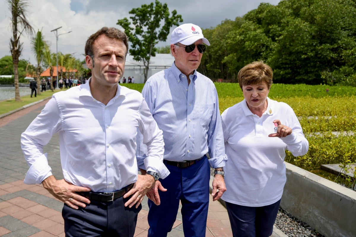 Le président américain Joe Biden (au centre) marche avec le président français Emmanuel Macron (à gauche) et la directrice générale du Fonds monétaire international Kristalina Georgieva (à droite) lors de leur visite d'une forêt de conservation de la mangrove en marge du sommet du G20 à Nusa Dua, sur l'île balnéaire indonésienne de Bali, le 16 novembre 2022. (Photo par Bay Ismoyo / Pool / AFP)